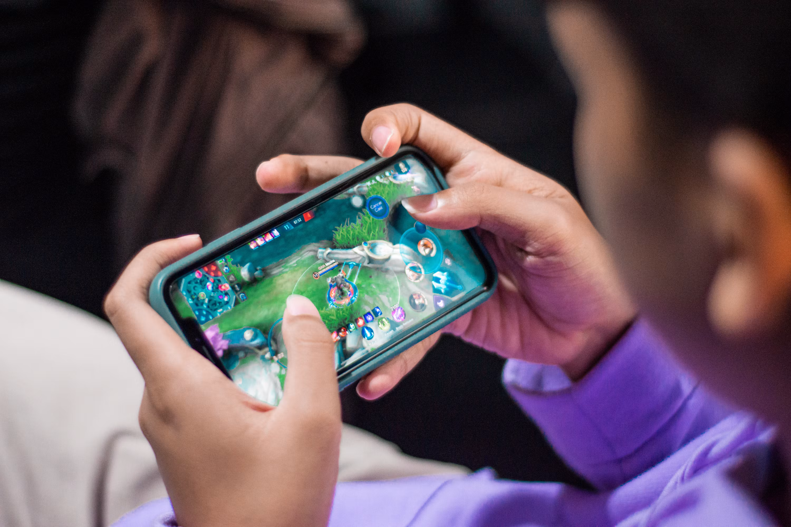 Large smartphone presenting a detailed fictional beginner-friendly gaming demonstration on screen